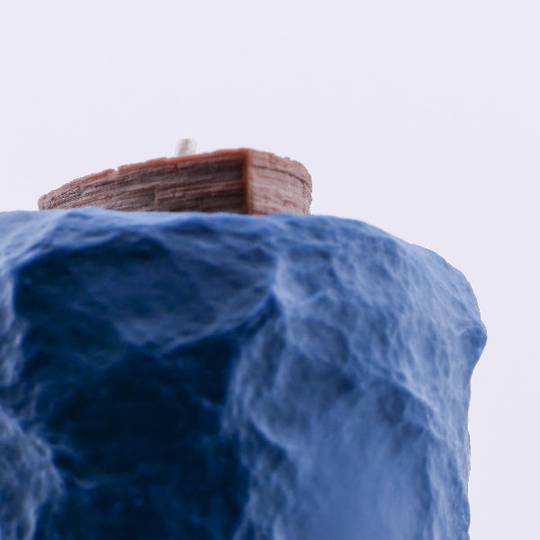 Model of a ship on a blue wave-like surface with a white background