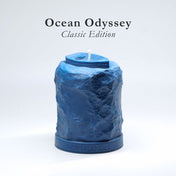 Blue textured candle labeled 'Ocean Odyssey Classic Edition' on a white background