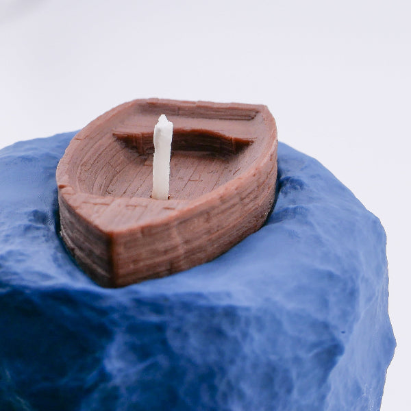 Brown wooden model ship on a wave surface with a white background